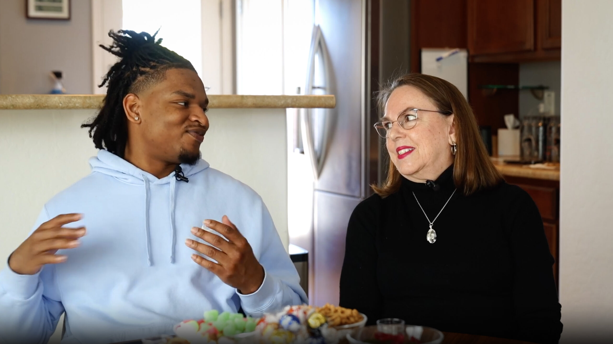 A grandmother and grandson during a family interview at the kitchen counter